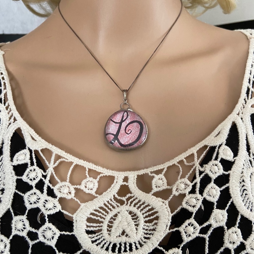 2 “L” Pendants: Silver/resin and plastic knotwork